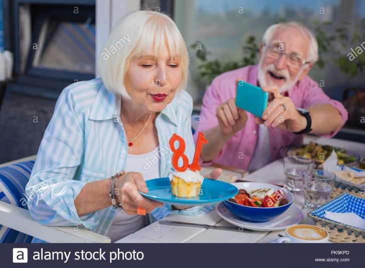 Woman Birthday Cake Positive Aged Woman Holding A Plate With Birthday Cake Stock Photo Woman Birthday Cake Positive Aged Woman Holding A Plate With Birthday Cake Stock Photo